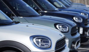 In this Friday, Feb. 18, 2022, photograph, a line of unsold 2022 Countryman utility vehicles on display at a Mini dealership in Highlands Ranch, Colo. (AP Photo/David Zalubowski)