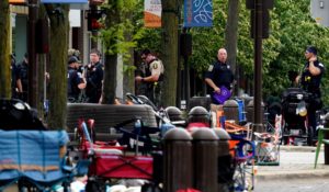 Law enforcement search after a mass shooting at the Highland Park Fourth of July parade in downtown Highland Park, Ill., on Monday. (AP Photo/Nam Y. Huh)