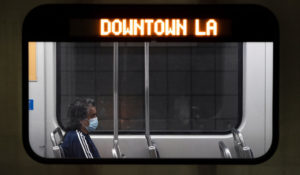 A commuter sits in a Los Angeles Metro train in Los Angeles, Wednesday, July 13, 2022. Los Angeles County, the nation's largest by population, is facing a return to a broad indoor mask mandate if current trends in hospital admissions continue, health director Barbara Ferrer told county supervisors Tuesday. (AP Photo/Jae C. Hong)