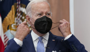 President Joe Biden removes his face mask as he arrives to speak at the White House on Thursday. Biden tested positive for COVID-19 again Saturday, slightly more than three days after he was cleared to exit coronavirus isolation, the White House said, in a rare case of “rebound” following treatment with an anti-viral drug. (AP Photo/Susan Walsh)