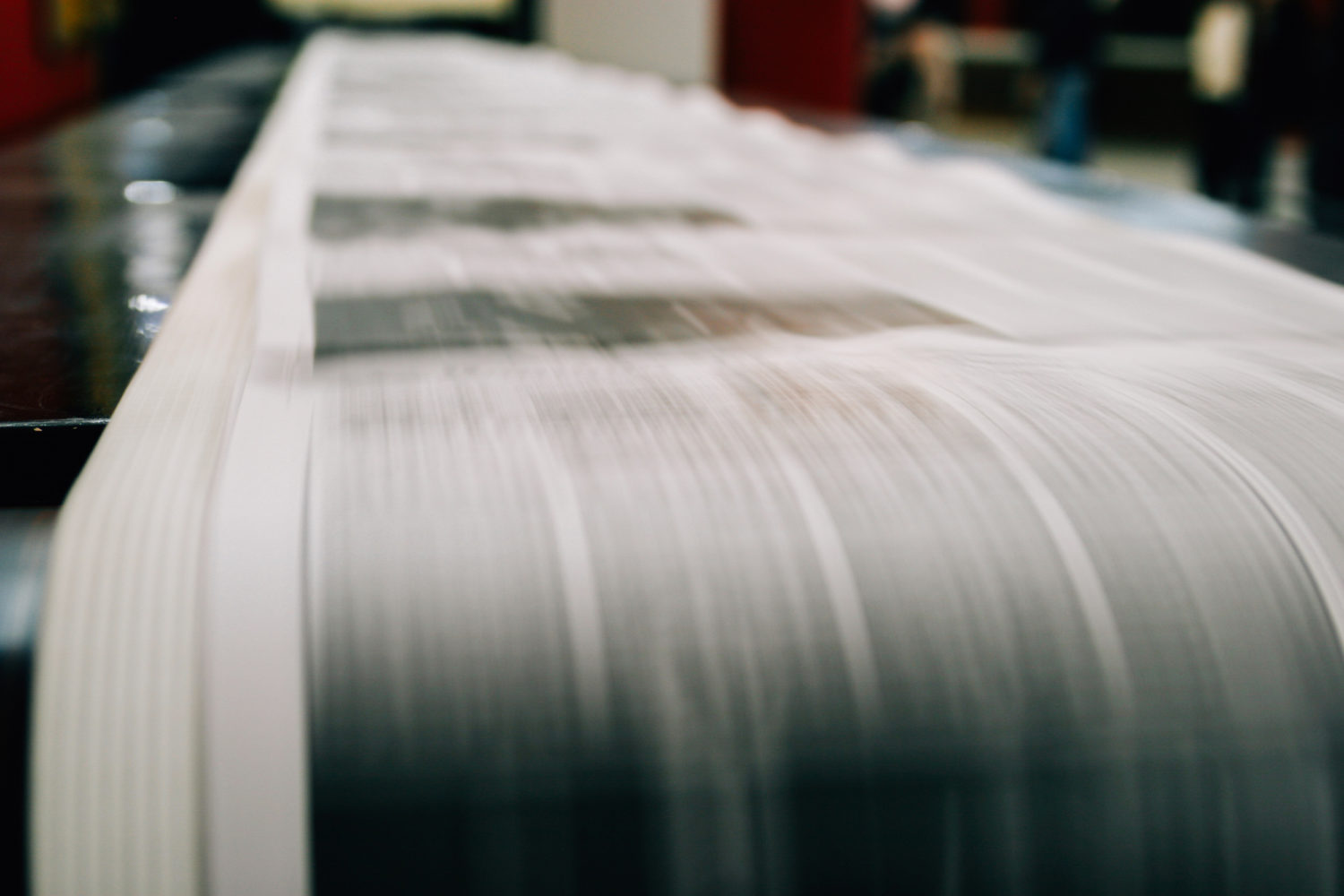 Newspaper being printed on rolls of paper