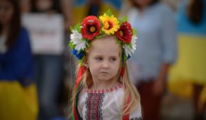 A Ukrainian refugee child wears a traditional flower crown during an event marking the country's Independence Day and the six-month milestone of Russia's invasion, in Bucharest, Romania, on Wednesday. (AP Photo/Alexandru Dobre)