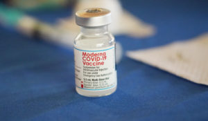 A vial of Moderna's original COVID-19 vaccine rests on a table at an inoculation station next to Jackson State University in Jackson, Miss., on July 19, 2022. (AP Photo/Rogelio V. Solis)