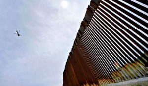 Casey Russell, an air and marine interdiction agent with U.S. Customs and Border Protection, patrols above the 30-foot high wall along the border with Mexico, Thursday, Sept. 8, 2022, in Sasabe, Ariz. This stretch is one of the deadliest along the international border. Border Patrol agents performed 3,000 rescues in the sector in the past 12 months. (AP Photo/Matt York)