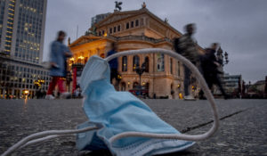 A view of a discarded face mask in front of the Old Opera, in Frankfurt, Germany, Thursday, March 31, 2022. (AP Photo/Michael Probst)