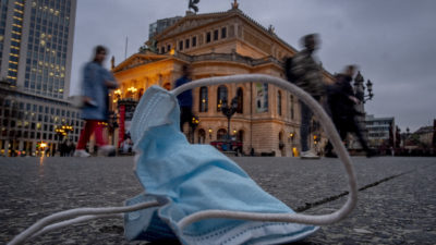 A view of a discarded face mask in front of the Old Opera, in Frankfurt, Germany, Thursday, March 31, 2022. (AP Photo/Michael Probst)