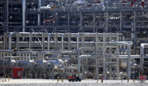 A small vehicle drives past a network of piping that makes up pieces of a "train" at Cameron LNG export facility in Hackberry, La., on March 31, 2022. (AP Photo/Martha Irvine, File)