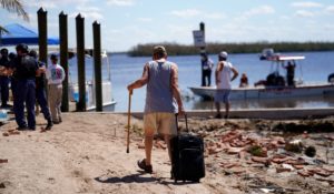 Residents who rode out the storm arrive at a dock to evacuate by boat in the aftermath of Hurricane Ian, on Pine Island in Florida's Lee County on Sunday. (AP Photo/Gerald Herbert)