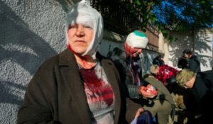 People receive medical treatment at the scene of Russian shelling, in Kyiv, Ukraine, on Monday. (AP Photo/Efrem Lukatsky)