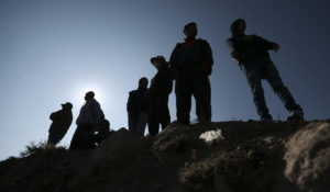 Migrants stand near the U.S.-Mexico border in Ciudad Juarez, Mexico on Monday. (AP Photo/Christian Chavez)