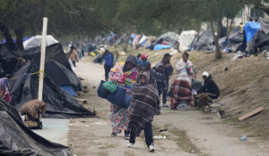 Venezuelan migrants camped along the U.S. border in Matamoros, Mexico, prepare for relocation to a nearby refugee shelter on Dec. 23 as they waited for the Supreme Court's ruling on Title 42. (AP Photo/Fernando Llano)