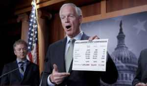 Sen. Ron Johnson, R-Wis., right, with Sen. Rand Paul, R-Ky., joins a group of Republican senators on Nov. 30 who threatened to withhold their votes to advance the National Defense Authorization Act unless it rescinded the requirement for members of the military to get vaccinated against COVID-19. (AP Photo/J. Scott Applewhite)