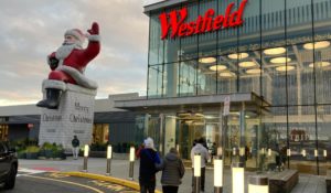 Shoppers pass a big Santa on display at the entrance of Westfield Garden State Plaza in Paramus, New Jersey, on Dec. 17. (AP Photo/Ted Shaffrey)