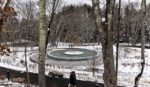 The Sandy Hook Permanent Memorial on Monday in Newtown, Conn. The names of the 20 first graders and six educators killed a short distance away at Sandy Hook Elementary School 10 years ago are engraved in concrete around a memorial pool with a sycamore tree in the middle. (AP Photo/Julia Nikhinson).