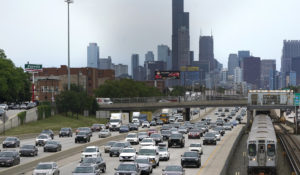 Motorists head southbound in the local and express lanes on Interstates 90-94 in slow and thickening traffic as a CTA train enters a station on the first day of the Fourth of July holiday weekend Friday, July 1, 2022, in Chicago. (AP Photo/Charles Rex Arbogast)