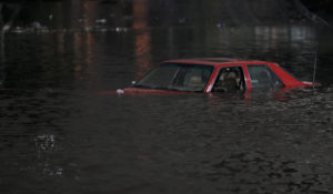 An empty vehicle is surrounded by floodwaters on a road in Oakland, Calif., Jan. 4, 2023. A new study says the drenching that California has been getting since Christmas will only get wetter and nastier with climate change. (AP Photo/Godofredo A. Vásquez, File)