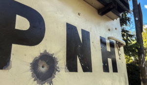 A bullet's impact is seen on an armored police car in Port-au-Prince, Haiti, Saturday, Jan. 21, 2023. One of Haiti's gangs stormed a key part of the capital, Port-Au-Prince, and battled with police throughout the day, leaving at least three officers dead and another missing. (AP Photo/Megan Janetsky)