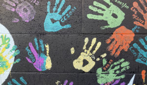 Some of the handprints of people recovering from drug addiction are seen on Dec. 9, 2021, on a wall in the parking lot of Provoking Hope, an addiction recovery center in McMinnville, Ore. (AP Photo/Andrew Selsky)