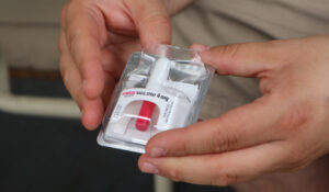 Joe Solomon, co-director of Charleston-based Solutions Oriented Addiction Response, holds a dose of the opioid overdose reversal drug Narcan at the Unitarian Universalist Congregation of Charleston in Charleston, W.Va., Tuesday Sept. 6, 2022. (AP Photo/Leah Willingham)