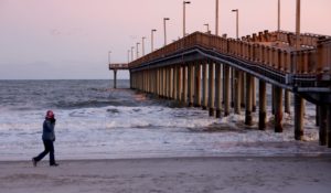 A person walks near the Springmaid Pier on Saturday, in Myrtle Beach, S.C. Earlier in the day, a Chinese balloon was shot down in the area. (AP Photo/Chris Seward)