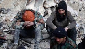 Men sitting on the wreckage of collapsed buildings in Aleppo, Syria on Tuesday. (AP Photo/Omar Sanadiki)