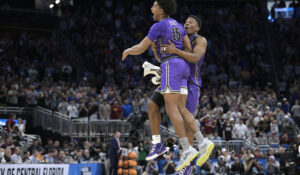 Furman players Tyrese Hughey and Alex Williams, right, celebrate their upset win against Virginia in the 2023 NCAA Tournament. (AP Photo/Phelan M. Ebenhack)