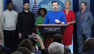 Jason Sudeikis, fourth from left, who plays the title character in the Apple TV+ series “Ted Lasso”, speaks as he joins White House press secretary Karine Jean-Pierre, third from left, and fellow cast members, from left, Toheeb Jimoh, Brett Goldstein, Hannah Waddingham, and Brendan Hunt, during the daily press briefing at the White House in Washington, Monday, March 20, 2023. (AP Photo/Susan Walsh)