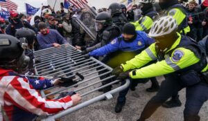 A scene from the U.S. Capitol on Jan. 6, 2021, as Trump supporters try to break through a police barrier. (AP Photo/John Minchillo)