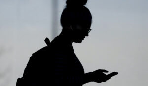 A woman checks her phone in Orem, Utah, on Nov. 14, 2019. (AP Photo/Rick Bowmer, File)