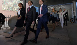 Davida Brook, left, Justin Nelson, second from left, and Stephen Shackelford, attorneys for Dominion Voting Systems, exit the New Castle County Courthouse in Wilmington, Del., on Tuesday. (AP Photo/Julio Cortez)
