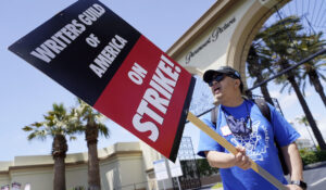 Ray Utarnachitt, a captain in the Writers Guild of America West, pickets with others at an entrance to Paramount Pictures on Tuesday. (AP Photo/Chris Pizzello)