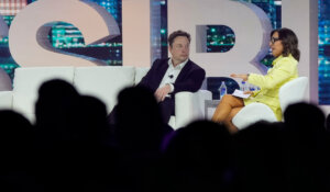 Twitter CEO Elon Musk and his newly-named replacement, Linda Linda Yaccarino, talk during a marketing conference in Miami in April. (AP Photo/Rebecca Blackwell, File)