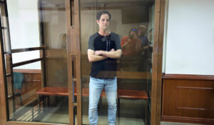 Wall Street Journal reporter Evan Gershkovich stands in a glass cage in a courtroom at the Moscow City Court in Moscow on Thursday. (AP Photo/Dmitry Serebryakov)