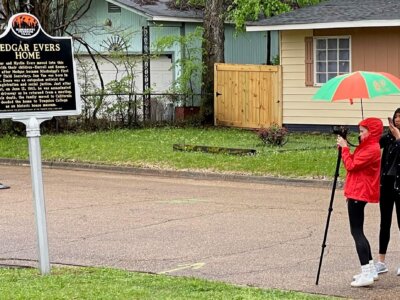 Serra Sowers (left) and Gabriela Rodriguez, part of the UFxFAMU1963 student group, do multimedia reporting outside the home of Medgar Evers in Jackson, Mississippi. (Herbert Lowe)