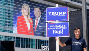 A Trump supporter stands outside Fiserv Forum in Milwaukee ahead of tonight’s GOP presidential debate. (AP Photo/Morry Gash)