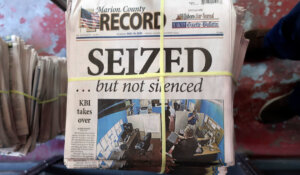 A stack of the latest weekly edition of the Marion County Record sits in the back of the newspaper's building, awaiting unbundling, sorting and distribution, on Wednesday in Marion, Kan. The newspaper's front page was dedicated to two stories about a raid by local police on its offices and the publisher's home on Aug. 11, 2023. (AP Photo/John Hanna)