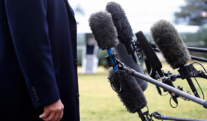 President Donald Trump stands in front of microphones as he speaks to members of the media on the South Lawn of the White House in Washington, Friday, Feb. 7, 2020. (AP Photo/Patrick Semansky, File)