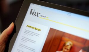 The Vox website is displayed on an iPad held by an Associated Press staffer in Los Angeles, on Tuesday, Sept. 1, 2015. (AP Photo/Richard Vogel)