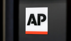 The Associated Press logo is displayed at the company's headquarters on April 18, 2017, in New York. (AP Photo/Jenny Kane)