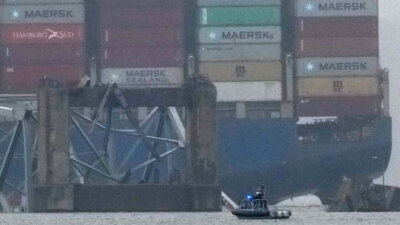 A container ship rests against the wreckage of the Francis Scott Key Bridge on Thursday, March 28, 2024, in Baltimore, Md. After days of searching through murky water for the workers missing after the bridge collapsed, officials are turning their attention Thursday to what promises to be a massive salvage operation. (AP Photo/Matt Rourke)