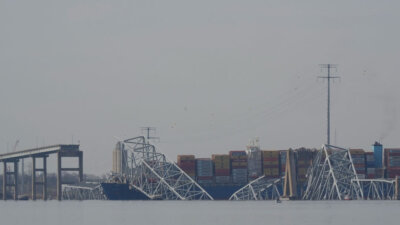 A container ship rests against wreckage of the Francis Scott Key Bridge on Tuesday in Baltimore. (AP Photo/Matt Rourke)