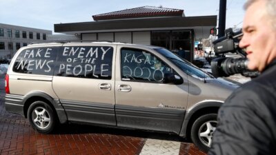 A counter-protester drives by a gathering outside the Catholic Diocese of Covington Tuesday, Jan. 22, 2019, in Covington, Ky. (AP Photo/John Minchillo)