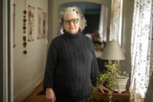 Lens founder Karen Gadbois in her home in New Orleans, La., in February 2024 (Emily Kask/Poynter)