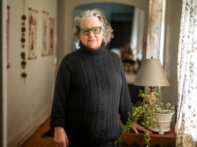 Lens founder Karen Gadbois in her home in New Orleans, La., in February 2024 (Emily Kask/Poynter)