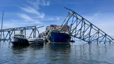 The fallen Francis Scott Key Bridge in Baltimore is pictured Sunday, March 31, 2024, where divers assisted crews with the complicated and meticulous operation of removing steel and concrete. (AP Photos/Mike Pesoli)