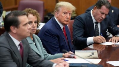 Former President Donald Trump sits at the defense table with his legal team in a Manhattan court, Tuesday, April 4, 2023, in New York. The first-ever trial of a former U.S. president will feature allegations that Trump falsified business records while compensating one of his lawyers, Michael Cohen, for burying stories about extramarital affairs that arose during the 2016 presidential race.(AP Photo/Seth Wenig, Pool)