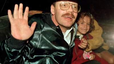 In this photo from Dec. 4, 1991, Associated Press reporter Terry Anderson grins with his 6-year-old daughter Sulome, following his release after six years in captivity. (AP Photo/Santiago Lyon)