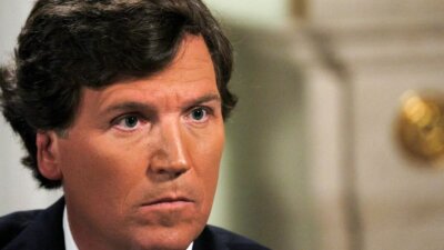 Former Fox News host Tucker Carlson listens during an interview with Russian President Vladimir Putin in February. (Gavriil Grigorov, Sputnik, Kremlin Pool Photo via AP)