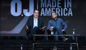 Then-ESPN executive Connor Schell, left, and filmmaker Ezra Edelman speak on stage during the "O.J. Made in America" panel at the ESPN 2016 Winter TCA in 2016. (Richard Shotwell/Invision/AP)