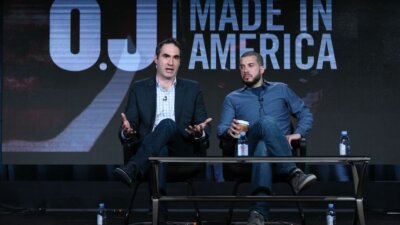 Then-ESPN executive Connor Schell, left, and filmmaker Ezra Edelman speak on stage during the "O.J. Made in America" panel at the ESPN 2016 Winter TCA in 2016. (Richard Shotwell/Invision/AP)